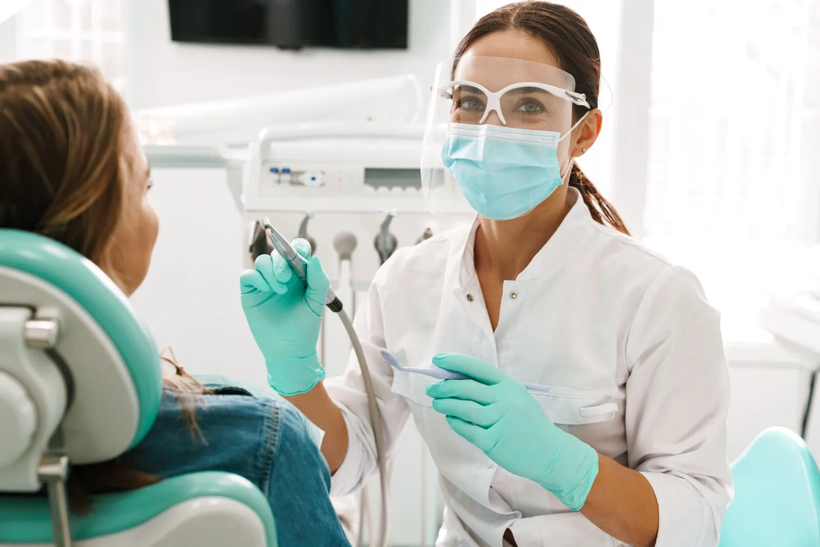 NewStart doctor discussing implant denture options with a patient
